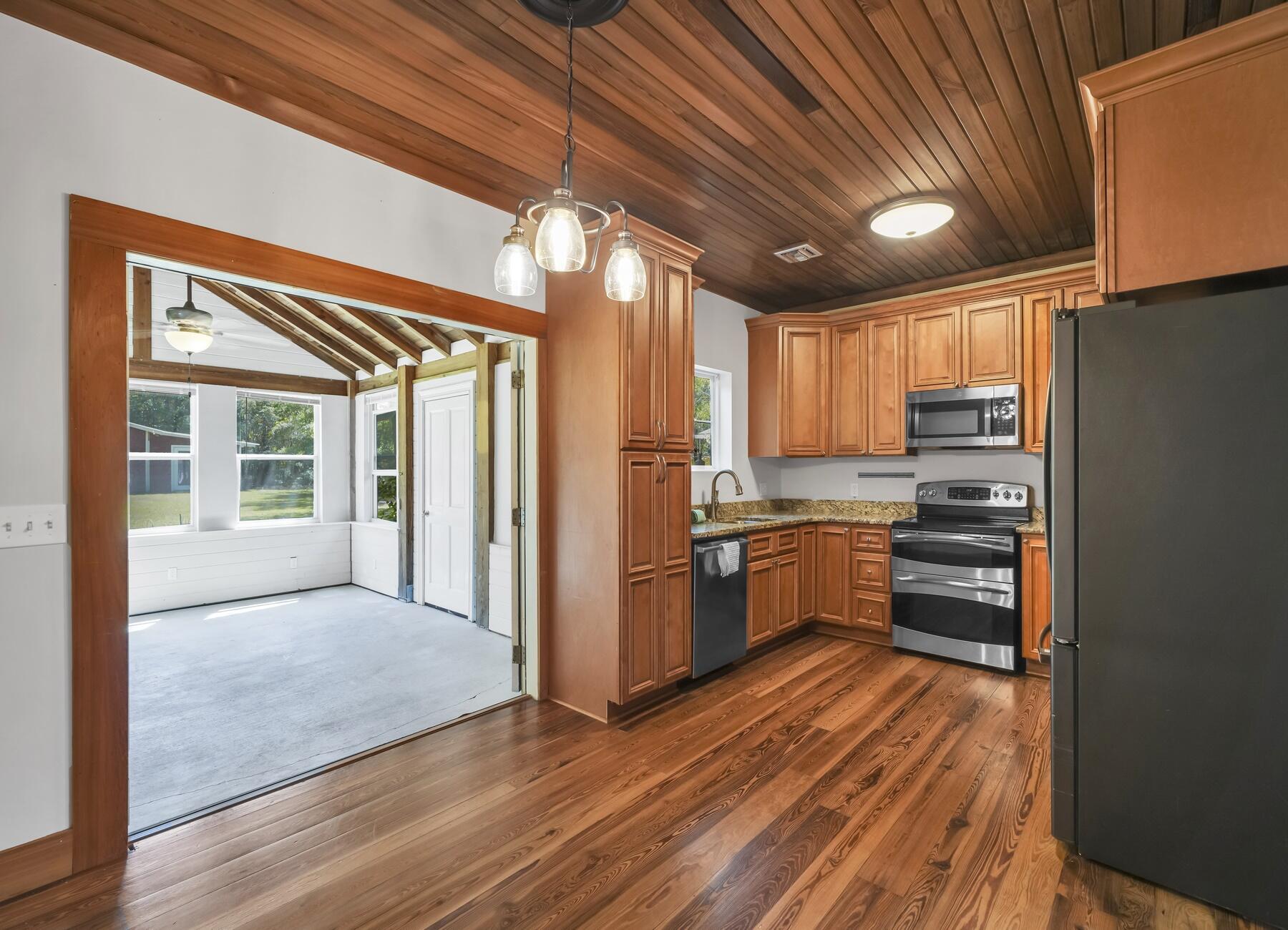 132 Hammock Oaks Boulevard Freeport, FL 32439 - Photo 15 of 45 a kitchen with granite countertop wooden floors and stainless steel appliances