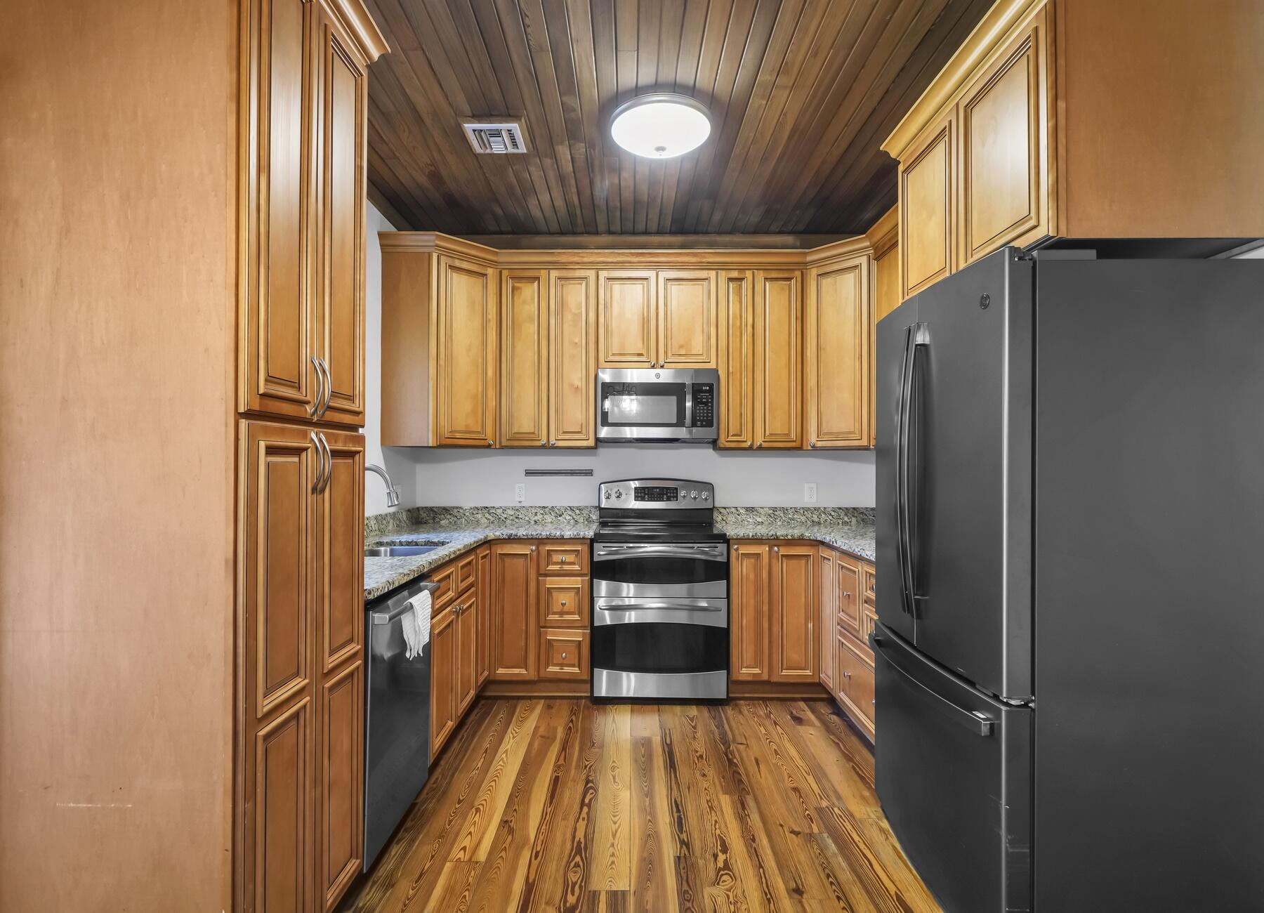 132 Hammock Oaks Boulevard Freeport, FL 32439 - Photo 16 of 45 a kitchen with stainless steel appliances granite countertop a refrigerator stove and sink