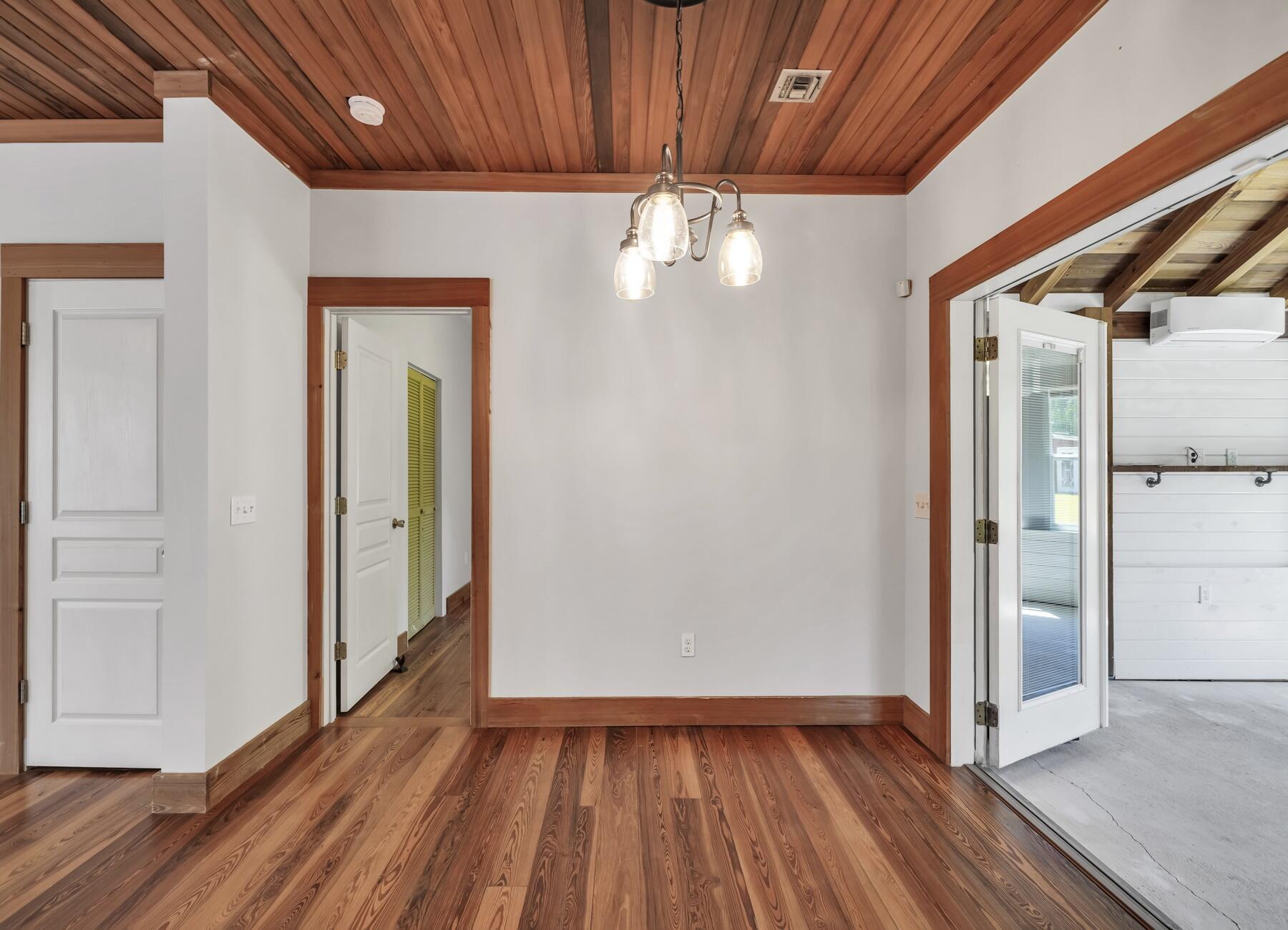 132 Hammock Oaks Boulevard Freeport, FL 32439 - Photo 19 of 45 a view of an empty room with wooden floor and a window