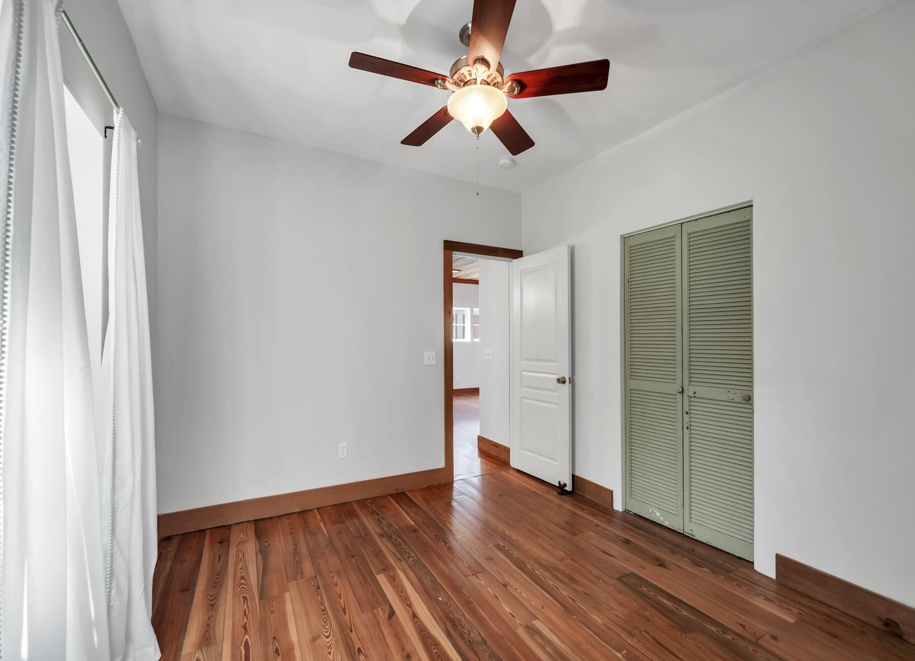 132 Hammock Oaks Boulevard Freeport, FL 32439 - Photo 21 of 45 wooden floor in an empty room with a window