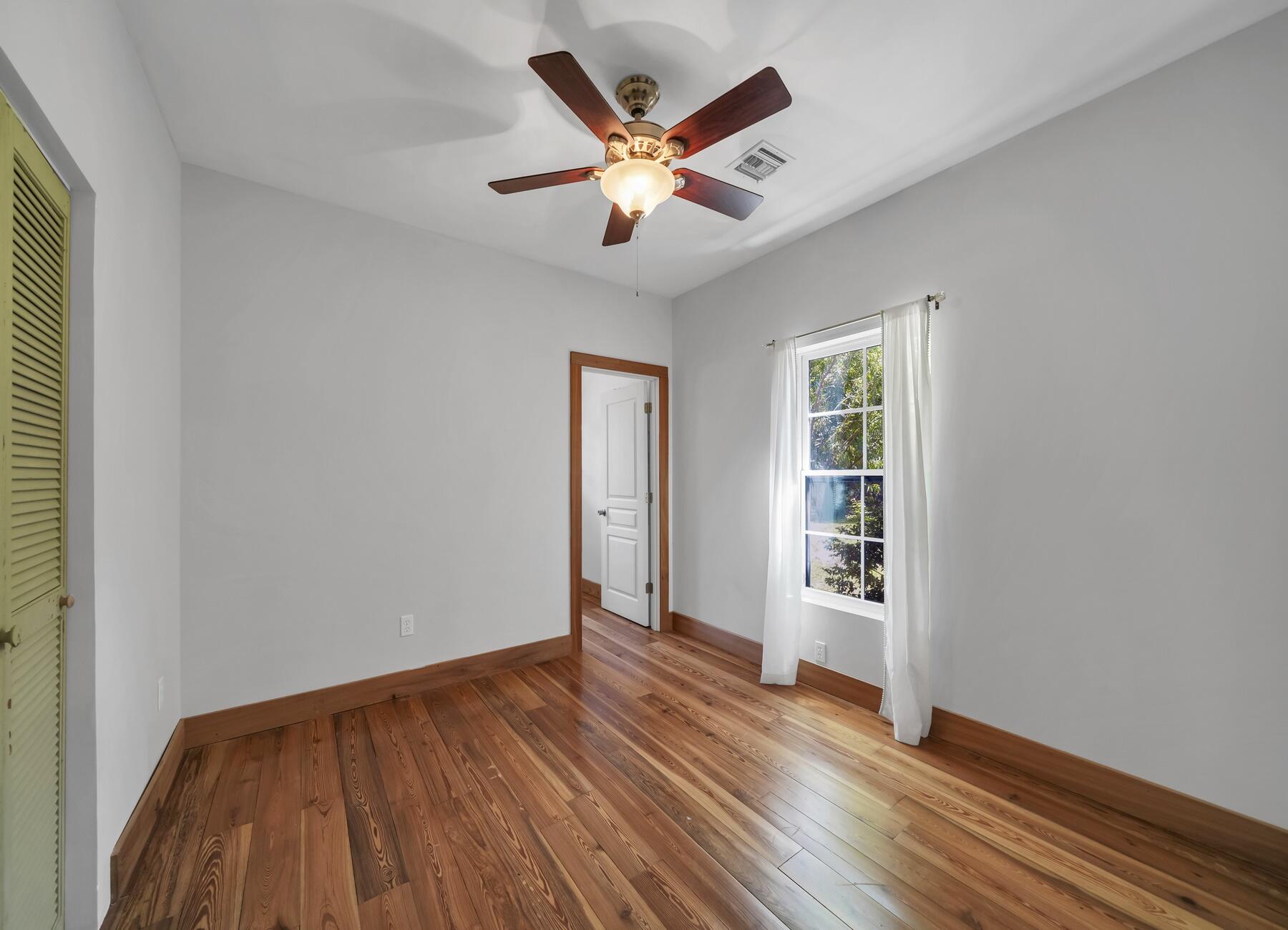132 Hammock Oaks Boulevard Freeport, FL 32439 - Photo 23 of 45 an empty room with wooden floor and ceiling fan
