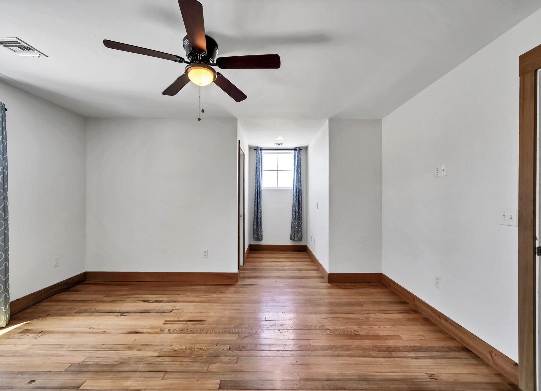 132 Hammock Oaks Boulevard Freeport, FL 32439 - Photo 26 of 45 a view of an empty room with window and wooden floor