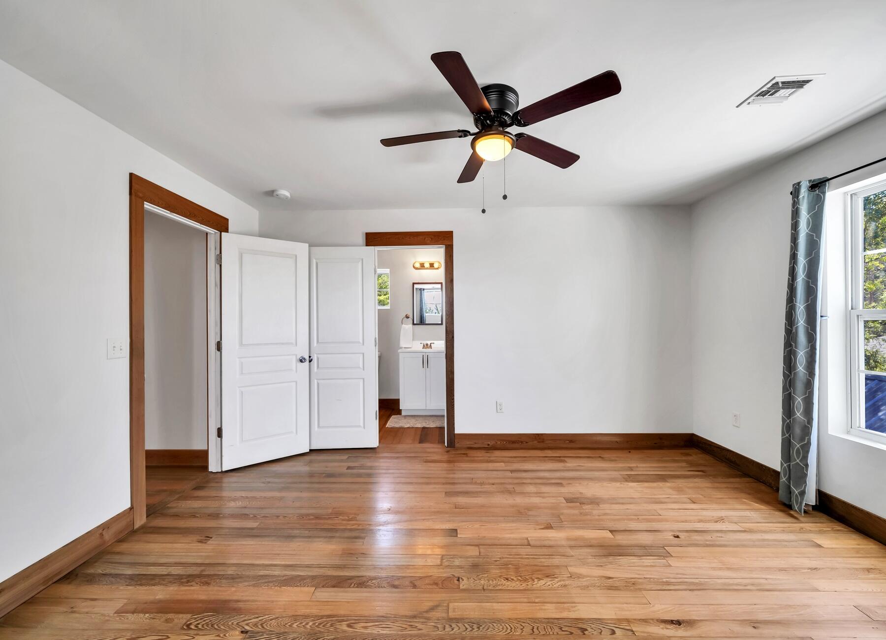 132 Hammock Oaks Boulevard Freeport, FL 32439 - Photo 28 of 45 an empty room with wooden floor and windows