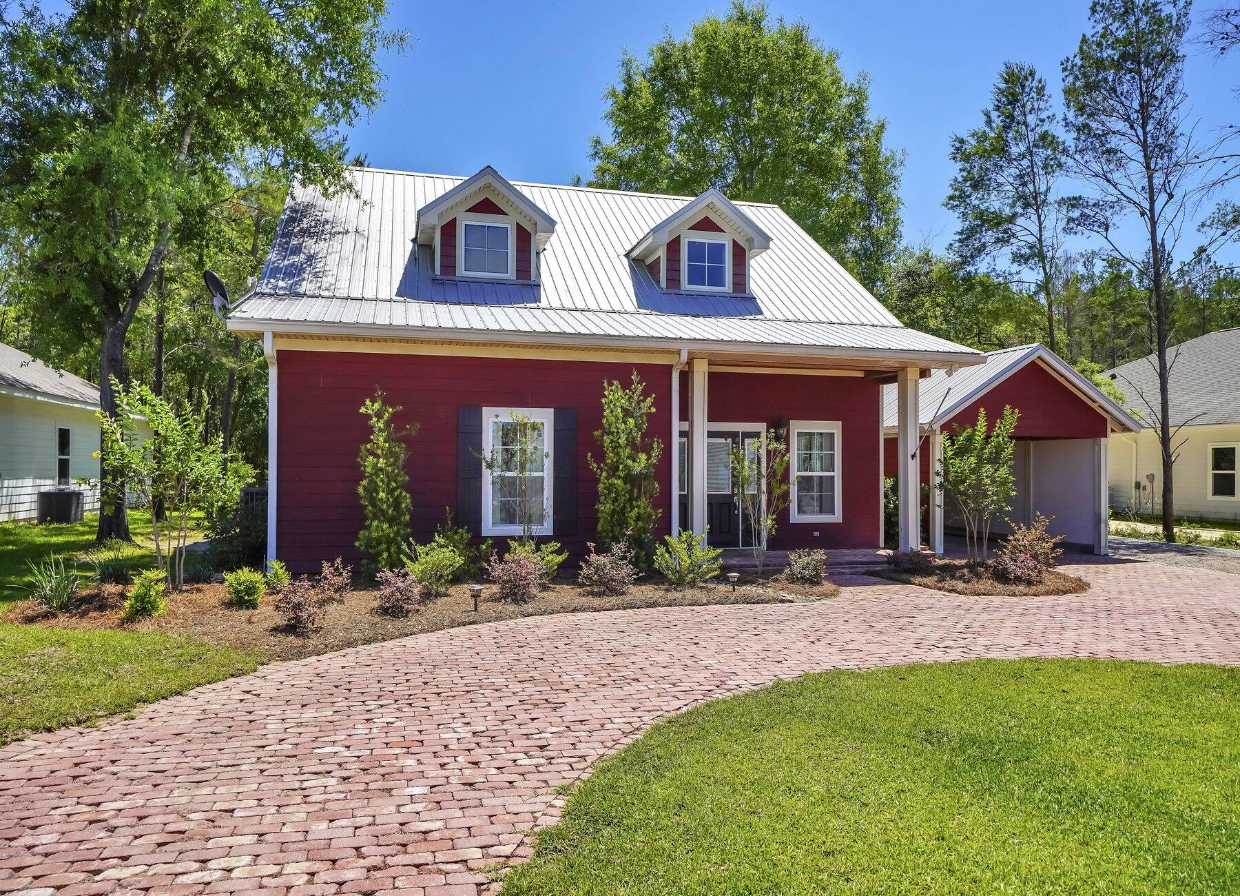 132 Hammock Oaks Boulevard Freeport, FL 32439 - Photo 3 of 45 a front view of a house with yard and trees in the background
