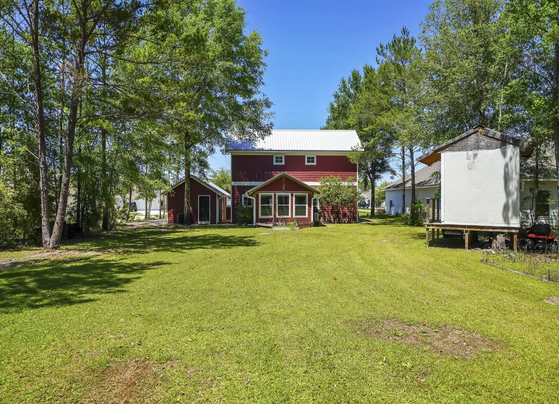 132 Hammock Oaks Boulevard Freeport, FL 32439 - Photo 40 of 45 a front view of house with yard and trees