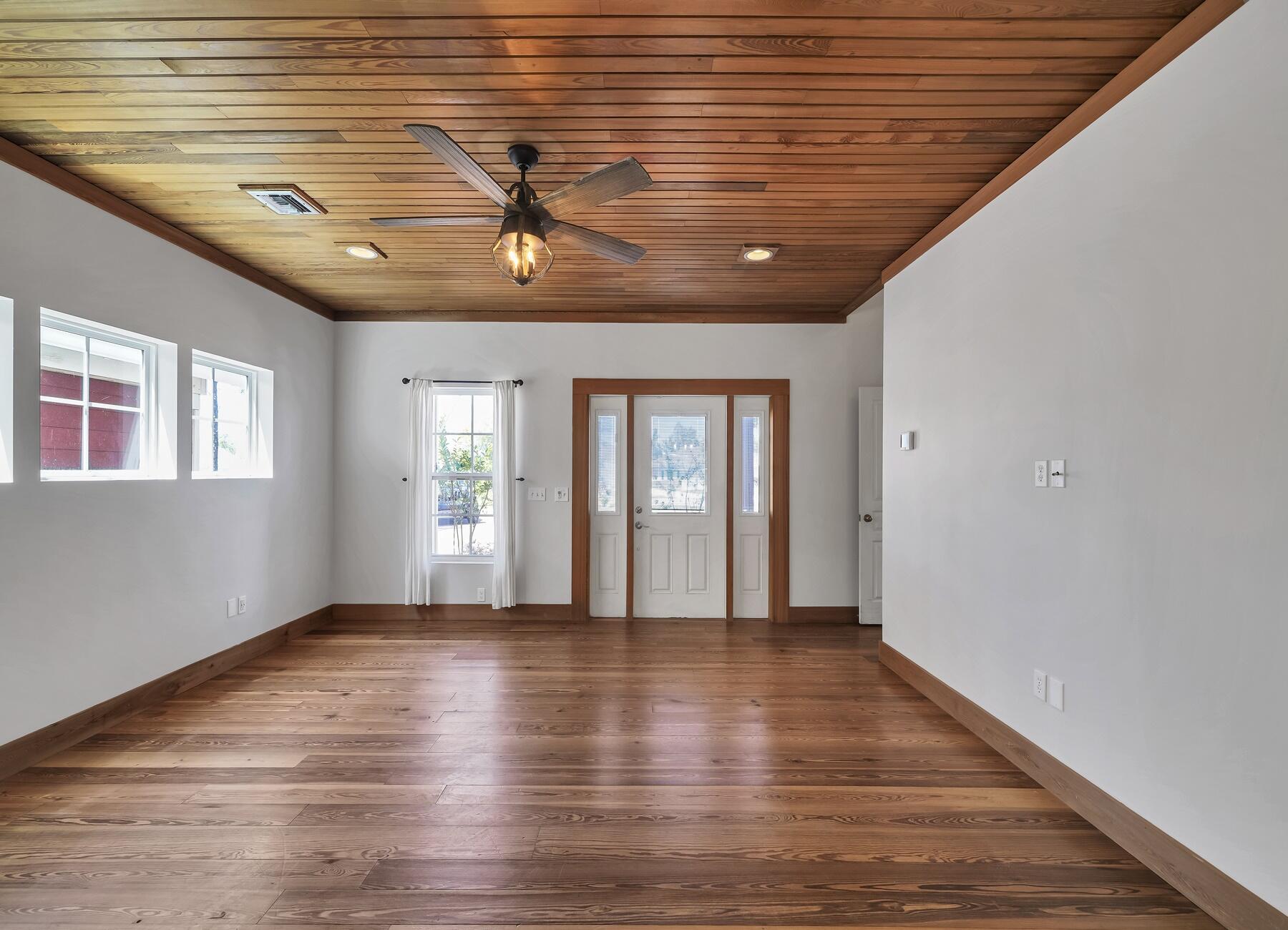 132 Hammock Oaks Boulevard Freeport, FL 32439 - Photo 4 of 45 a view of an empty room with wooden floor and a window