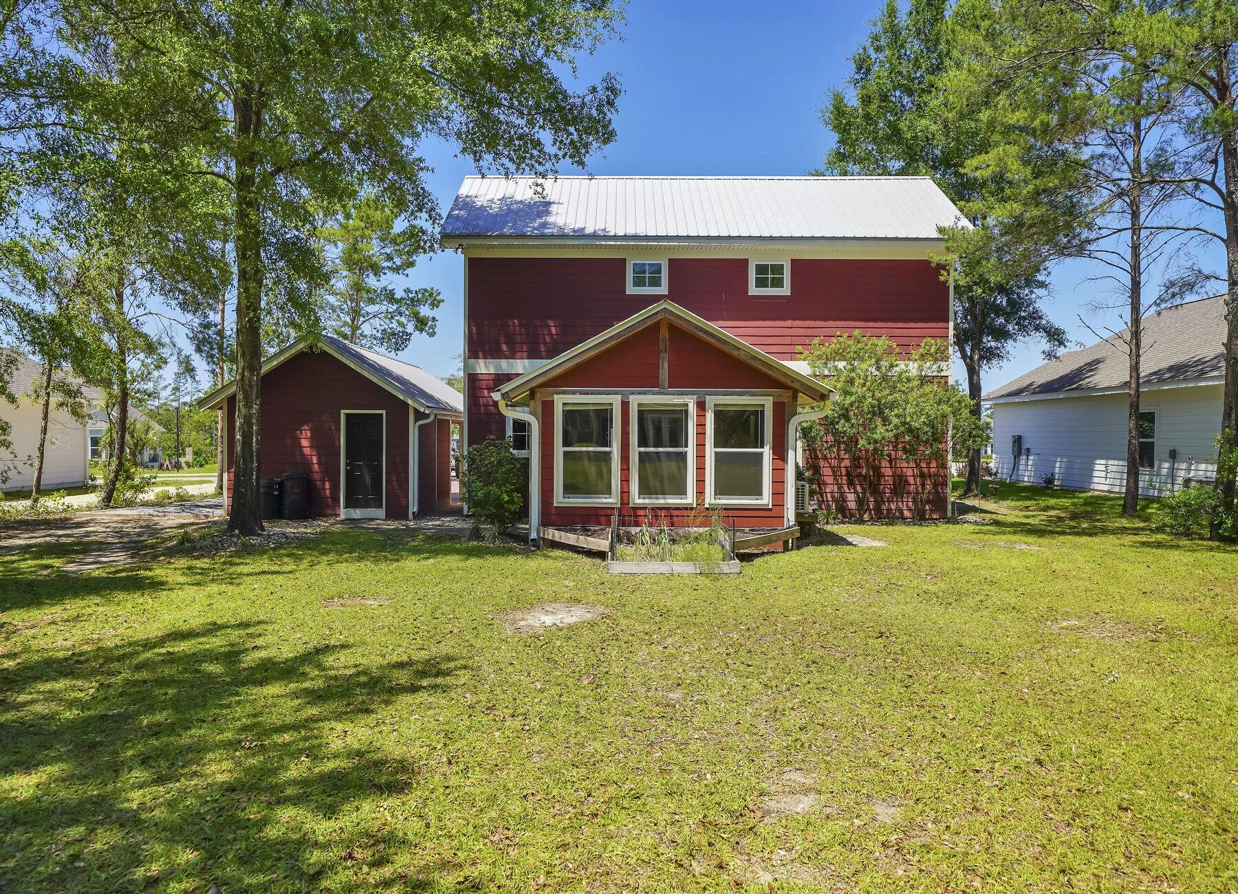 132 Hammock Oaks Boulevard Freeport, FL 32439 - Photo 41 of 45 a front view of a house with a yard