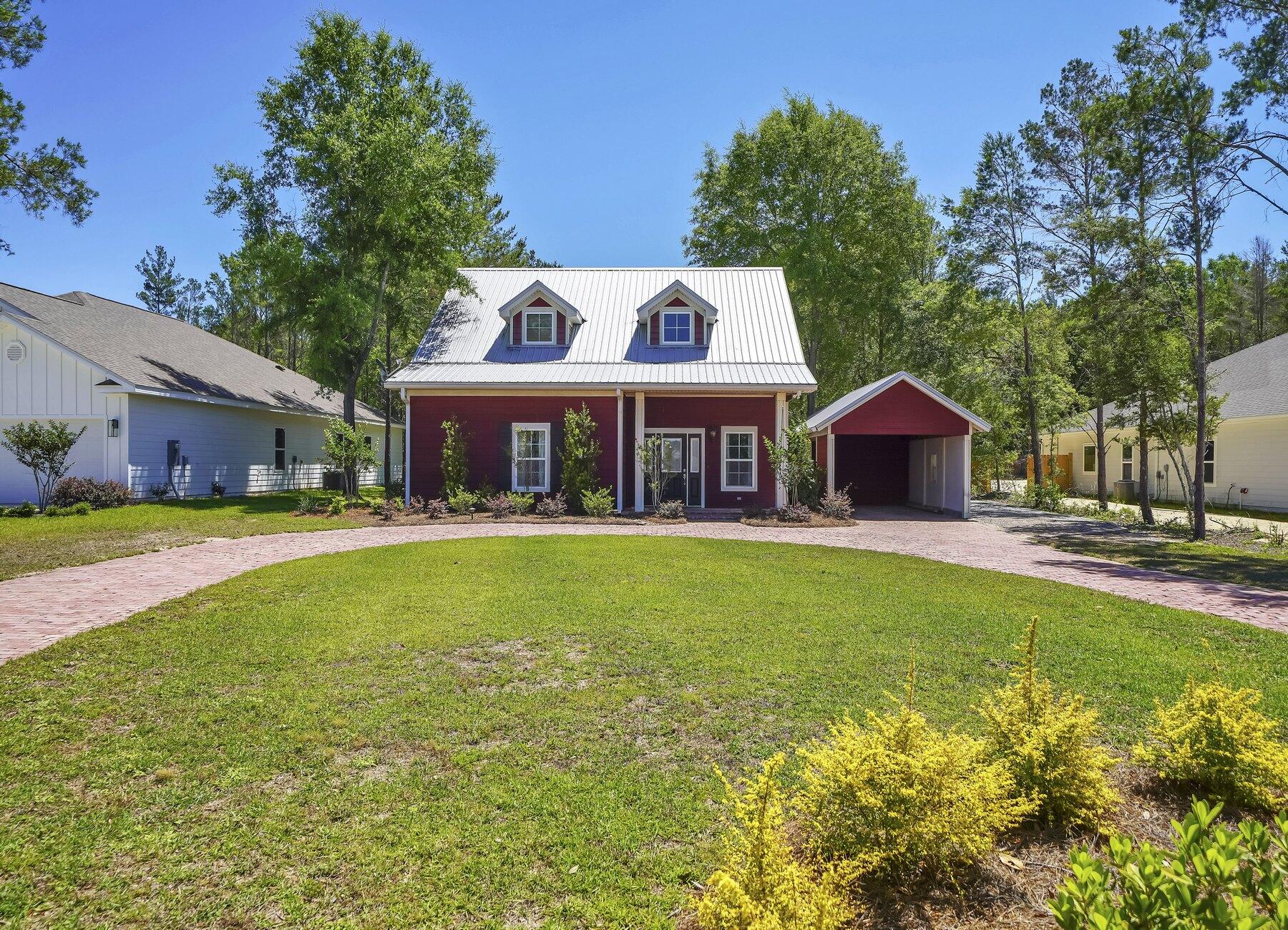 132 Hammock Oaks Boulevard Freeport, FL 32439 - Photo 44 of 45 a front view of a house with garden