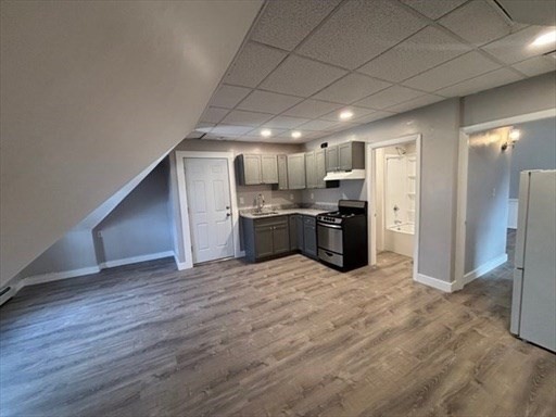 772 Rock Street Fall River, MA 02720 - Photo 4 of 17 a view of a electric appliances in kitchen and empty room with wooden floor