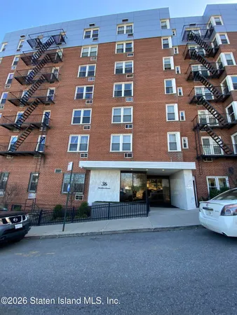 a view of building with car parked