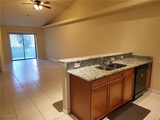a kitchen with a sink cabinets and a stove top oven