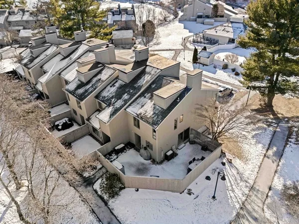 an aerial view of a residential apartment building with a yard