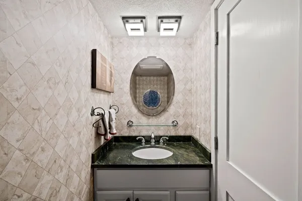 a spacious bedroom with a bed and a chandelier