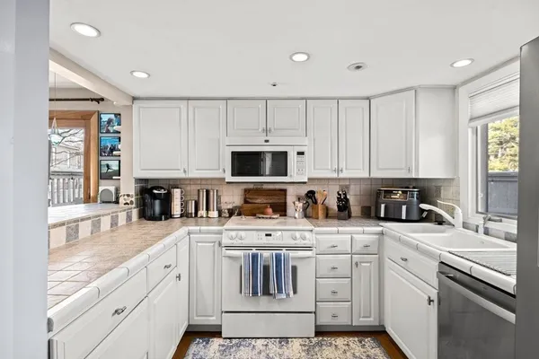 a kitchen with a refrigerator and a sink