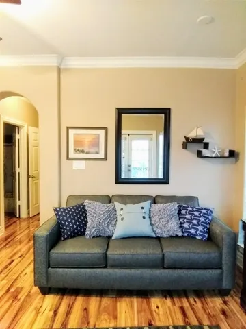 a living room with a couch and a lamp