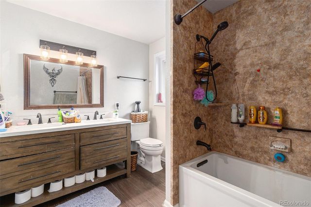 a bathroom with a bathtub sink mirror and toilet