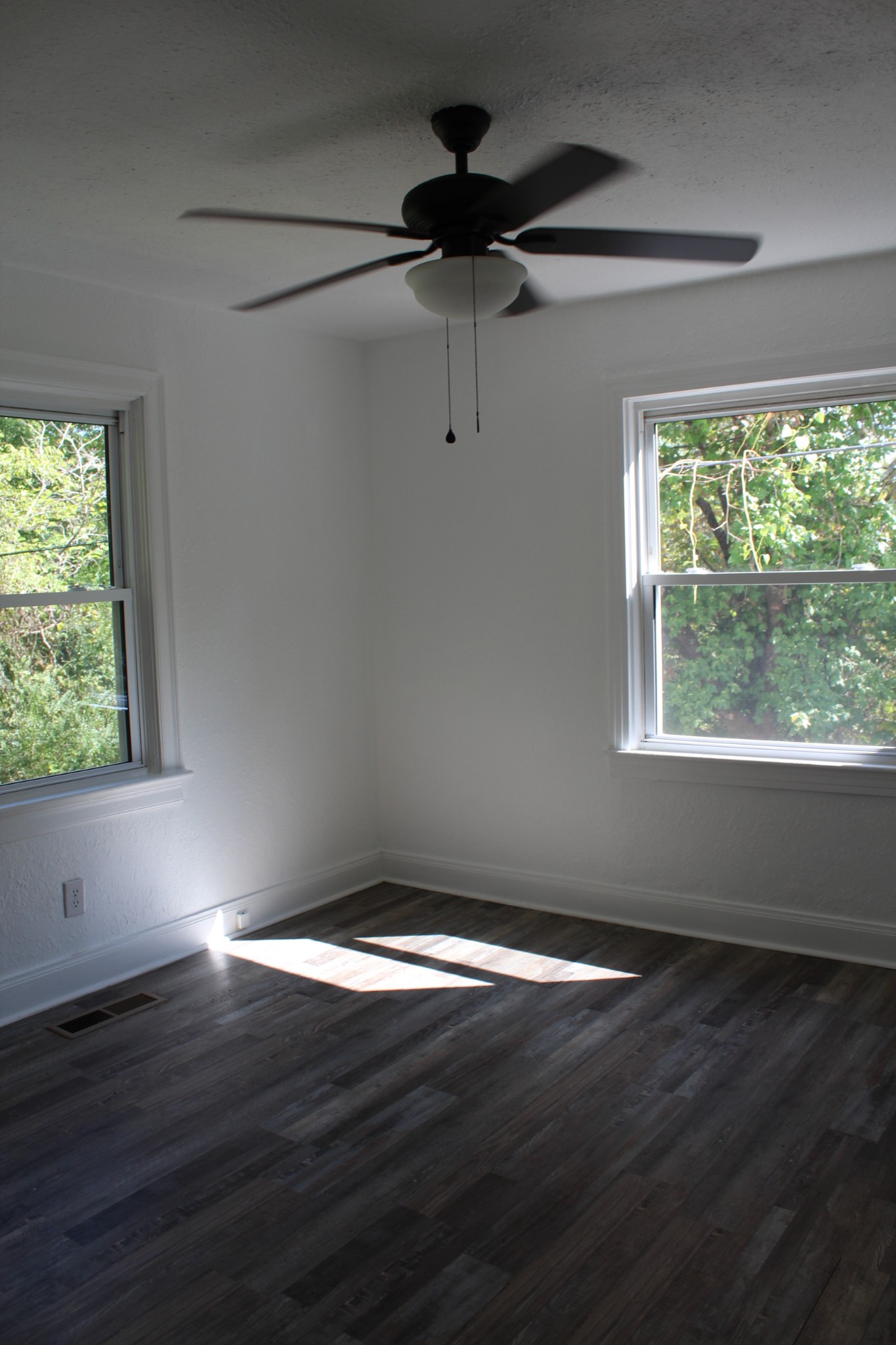 78 College Street Erin, TN 37061 - Photo 12 of 17 a view of a big room with wooden floor and windows
