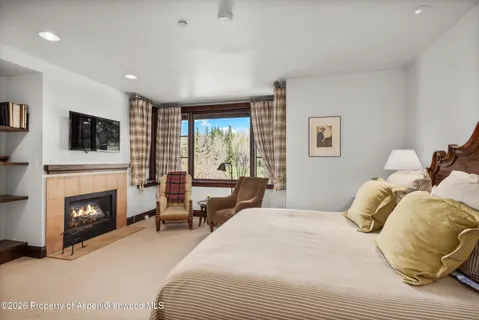 a bedroom with a bed and a fireplace
