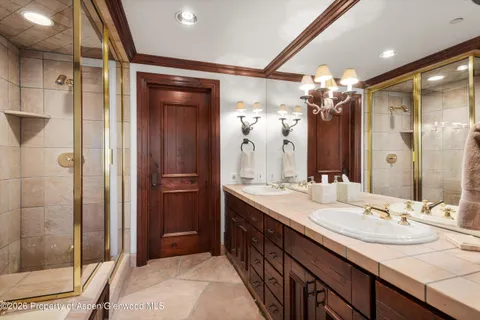 a bathroom with a sink double vanity and a shower