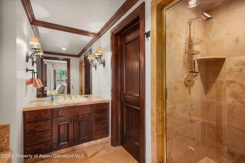 a bathroom with a double vanity sink mirror and shower