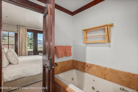 a bathroom with a tub and a window