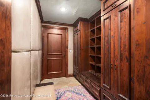 a view of a hallway with wooden floor and stairs