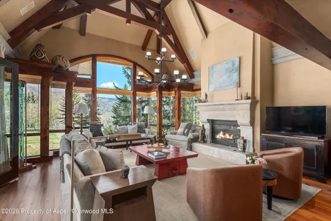 a living room with fireplace furniture and a flat screen tv