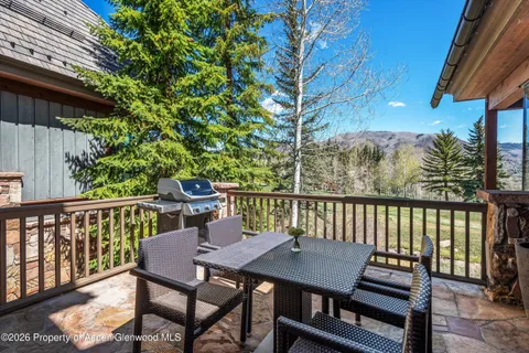 a view of a chairs and table on the deck
