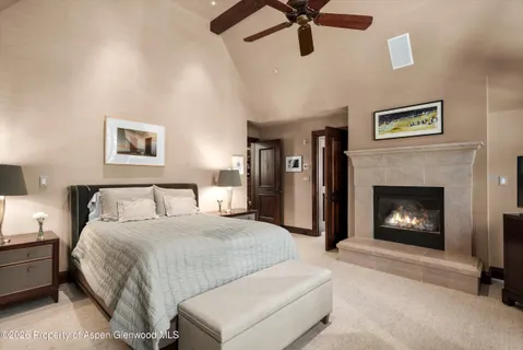 a bedroom with a bed and a fireplace