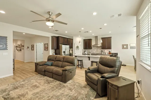a living room with furniture and kitchen view