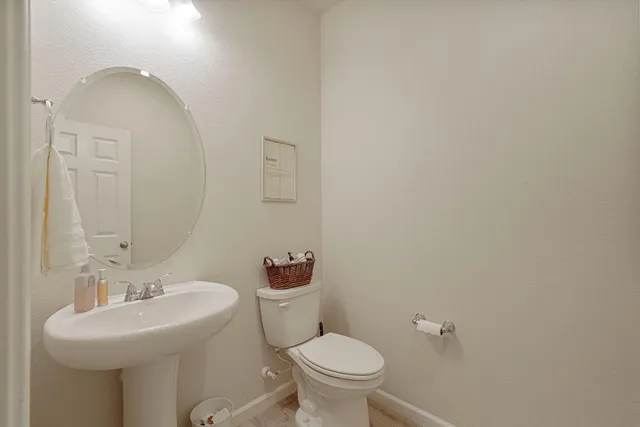 a bedroom with a bed and a ceiling fan