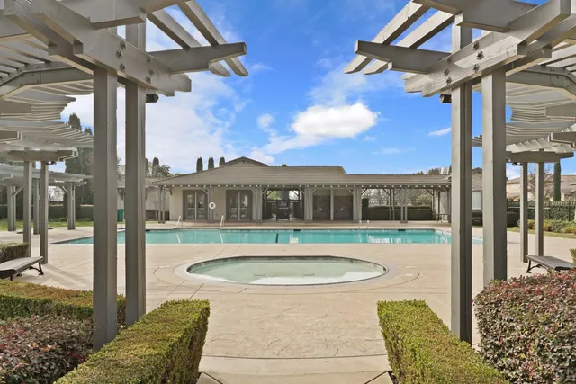 a lawn chairs sitting under a large umbrella