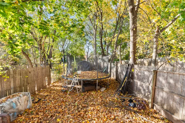 a backyard of a house with table and chairs