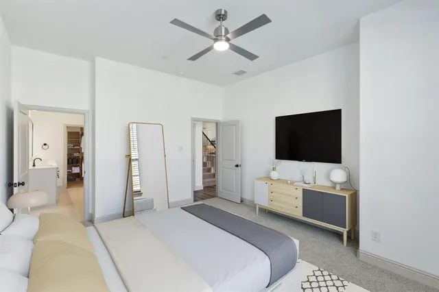 a bedroom with a bed and a flat screen tv