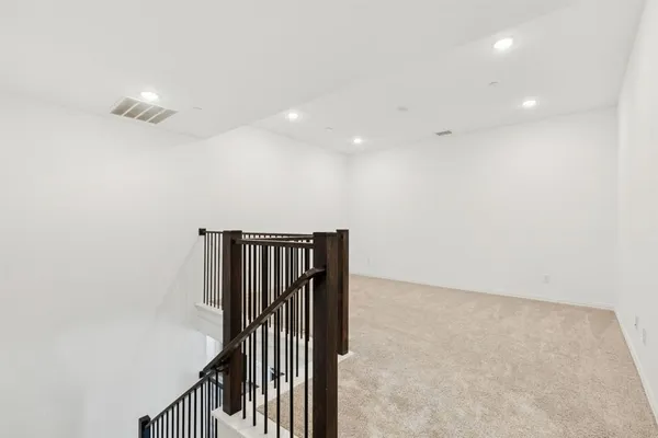 wooden floor in an empty room with stairs