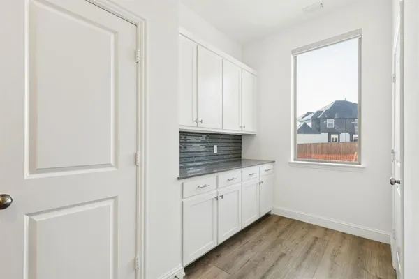 a kitchen with granite countertop white cabinets and sink