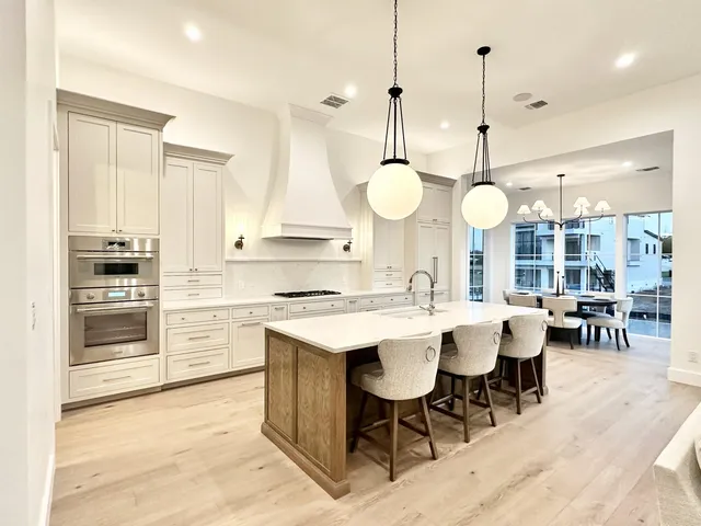 a large kitchen with a table and chairs