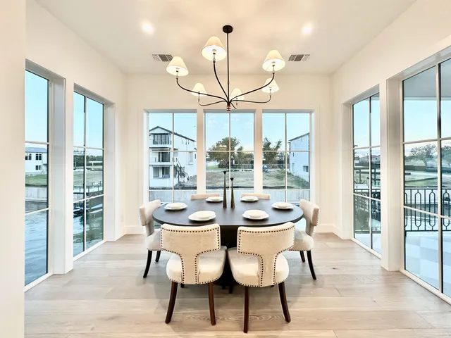 a view of a dining room with furniture wooden floor and chandelier