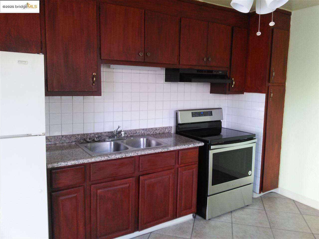 1109 Seminary Avenue Oakland, CA 94621 - Photo 12 of 51 a kitchen with a sink and a stove top oven