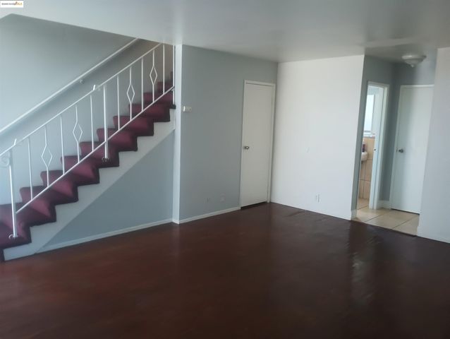 a view of an empty room with stairs