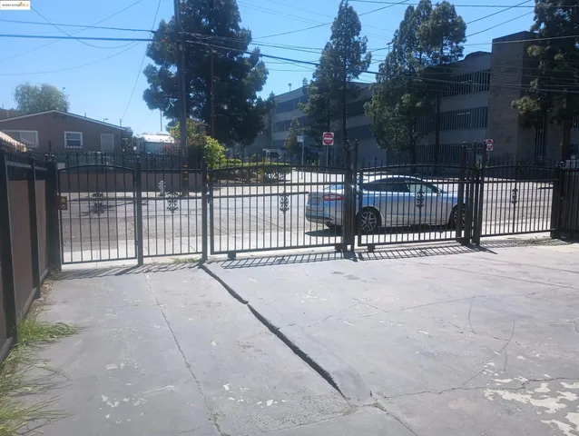a view of backyard and white fence