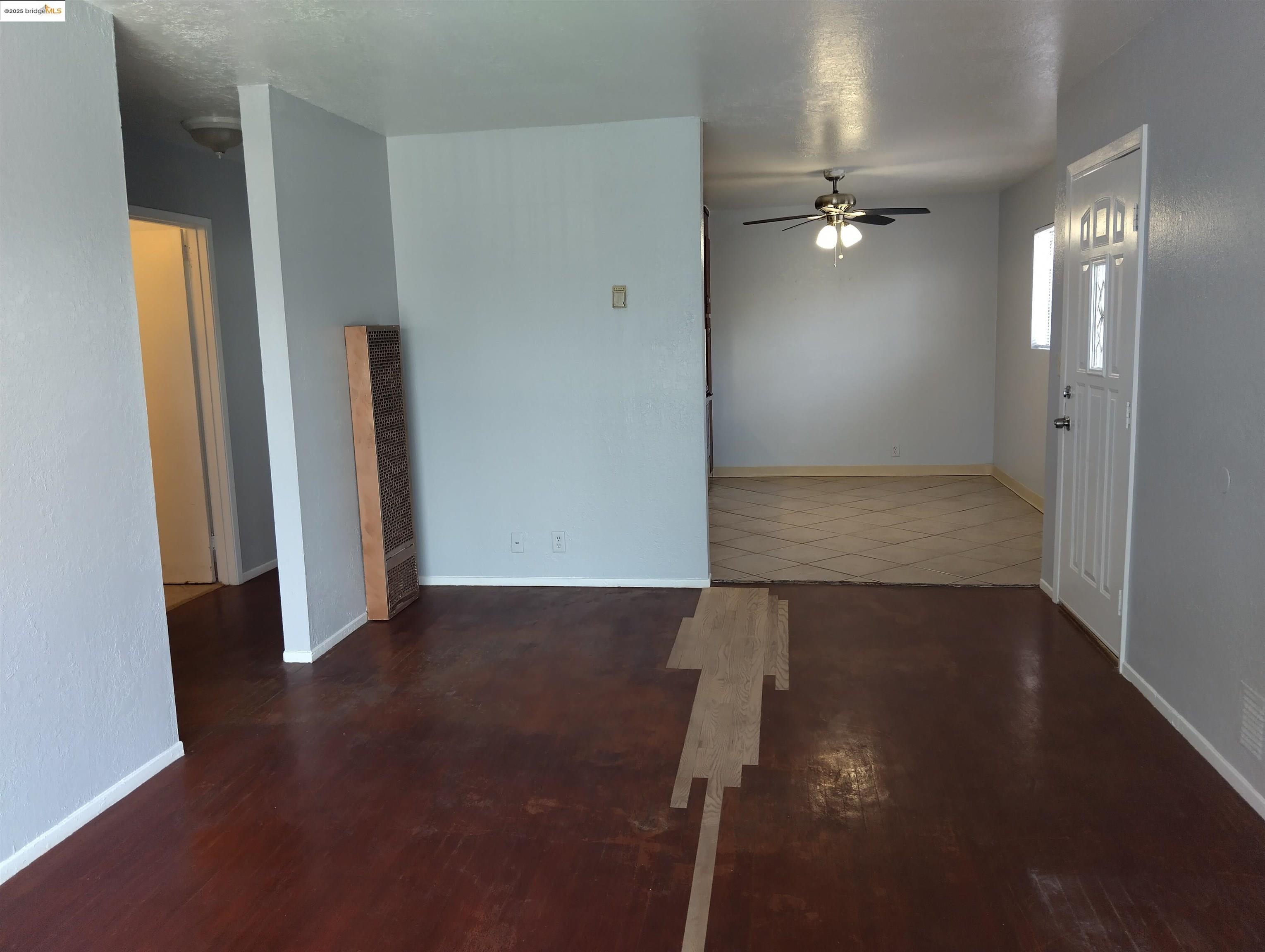 1109 Seminary Avenue Oakland, CA 94621 - Photo 38 of 51 an empty room with wooden floor and mirror
