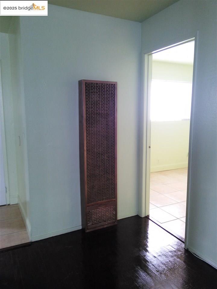1109 Seminary Avenue Oakland, CA 94621 - Photo 6 of 51 a view of an empty room with wooden floor and a window