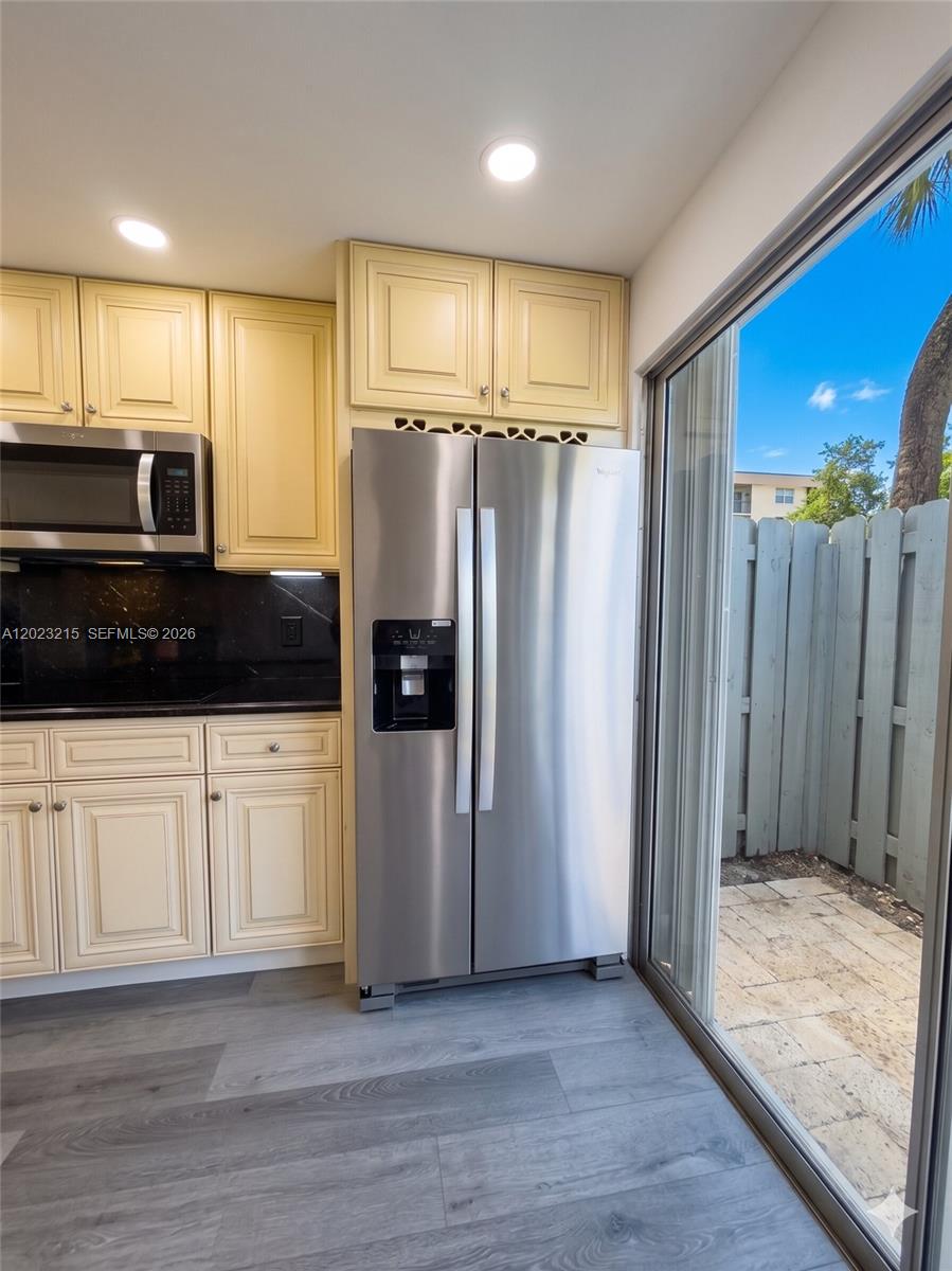 13 Southwest 3rd Street, Unit 13 Pompano Beach, FL 33060 - Photo 7 of 44 a kitchen with stainless steel appliances a refrigerator sink and microwave