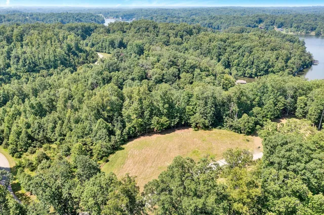an aerial view of a houses with a yard
