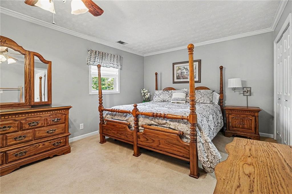 740 Smyrna Road Southwest Conyers, GA 30094 - Photo 12 of 27 a bedroom with a bed and a dresser