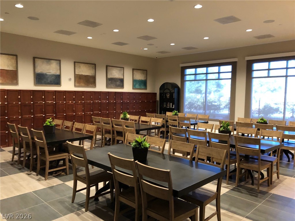 498 Pebble Run Avenue Henderson, NV 89011 - Photo 39 of 47 This spacious common area features rows of dark wood lockers, abundant seating, and large windows that invite natural illumination.