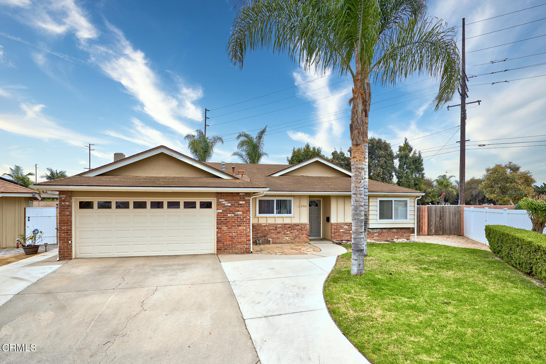 a front view of a house with a garden and yard