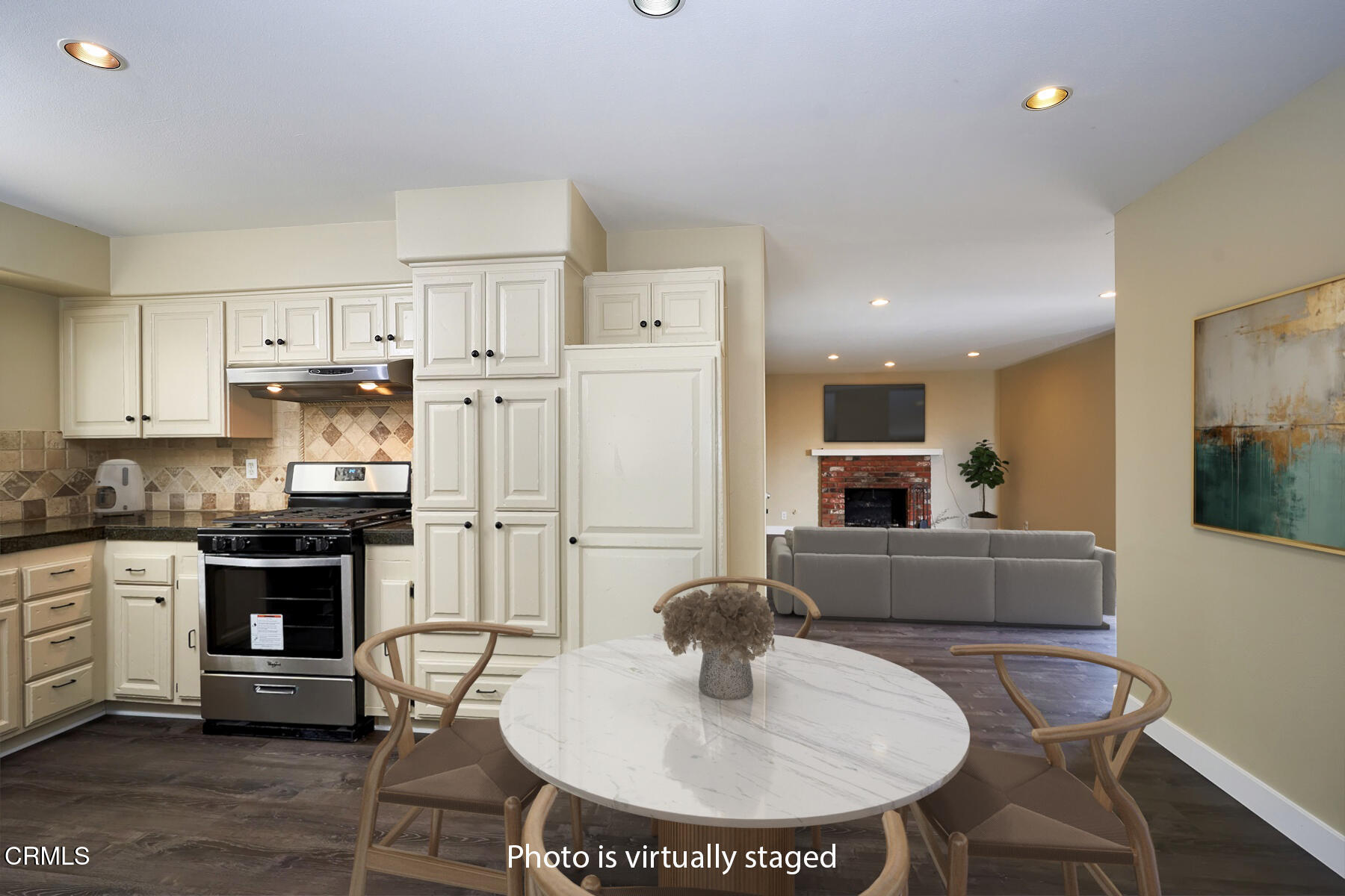 1700 Arlene Avenue Oxnard, CA 93036 - Photo 7 of 29 a kitchen with stainless steel appliances kitchen island granite countertop a stove a refrigerator a sink a dining table and chairs