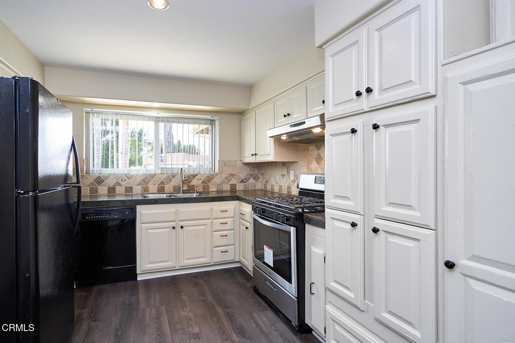 1700 Arlene Avenue Oxnard, CA 93036 - Photo 10 of 29 a kitchen with granite countertop white cabinets and stainless steel appliances